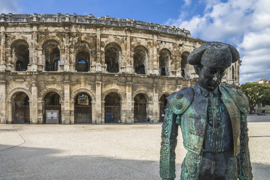 A statue of a matador outside of an ancient coliseum in Arles, Provence.