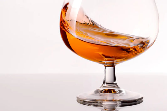 A glass of cognac swirling in a glass.