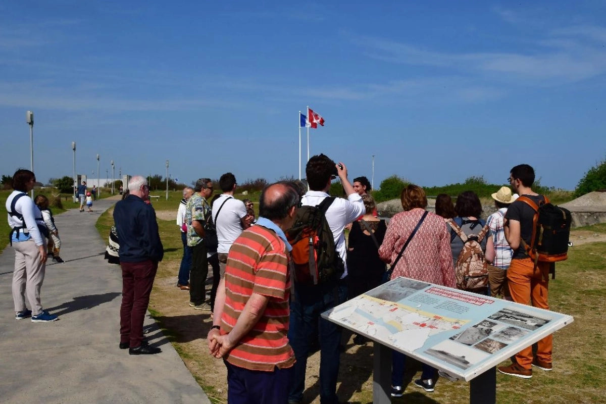 Tourists listen to a guide at the Juno Beach Centre.