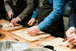Load image into Gallery viewer, A class prepares food at a cooking class in Paris.
